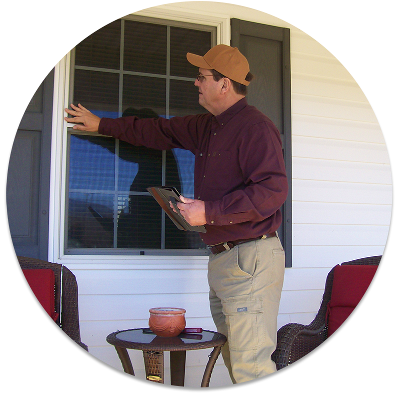 Bill home inspector inspecting the windows outside of a residential home