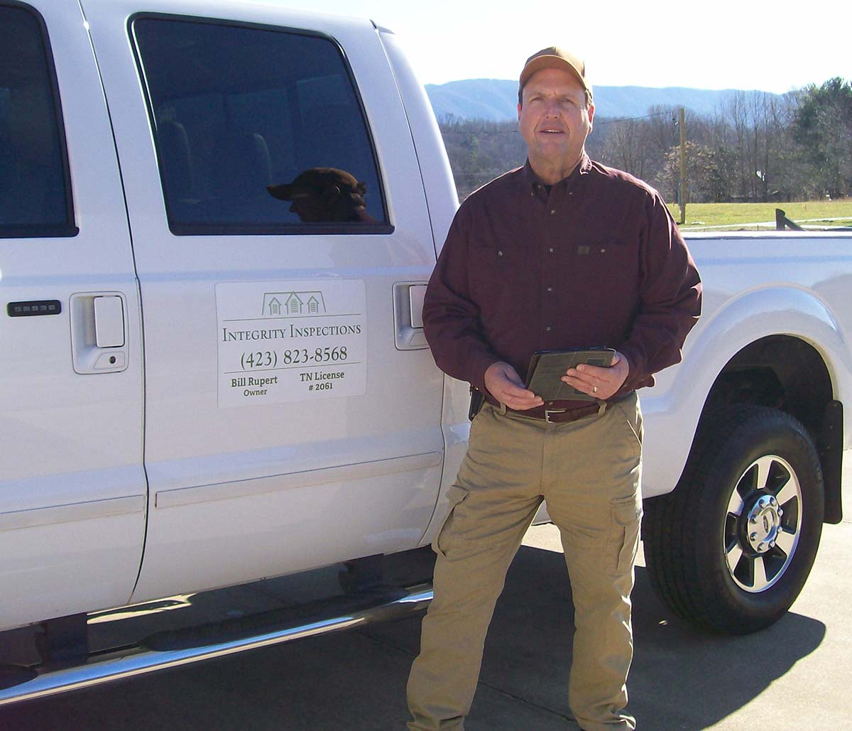 Bill Rupert, one of Integrity's home inspectors, standing next to his truck