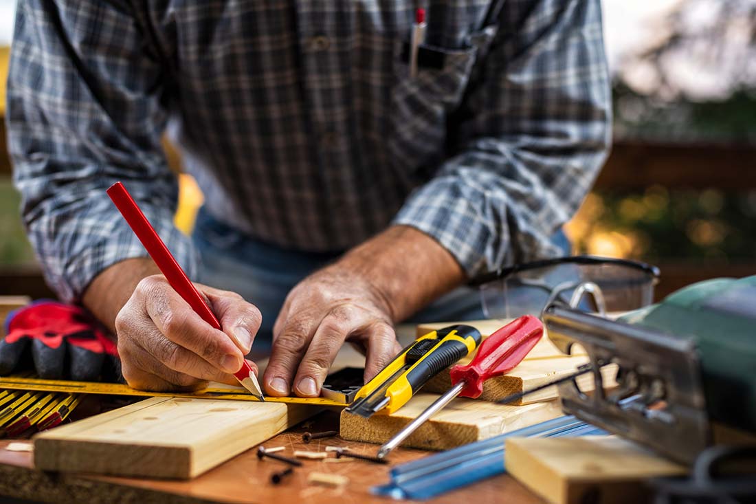 A craftsman using tools to make a repair, which will be checked during home inspection services